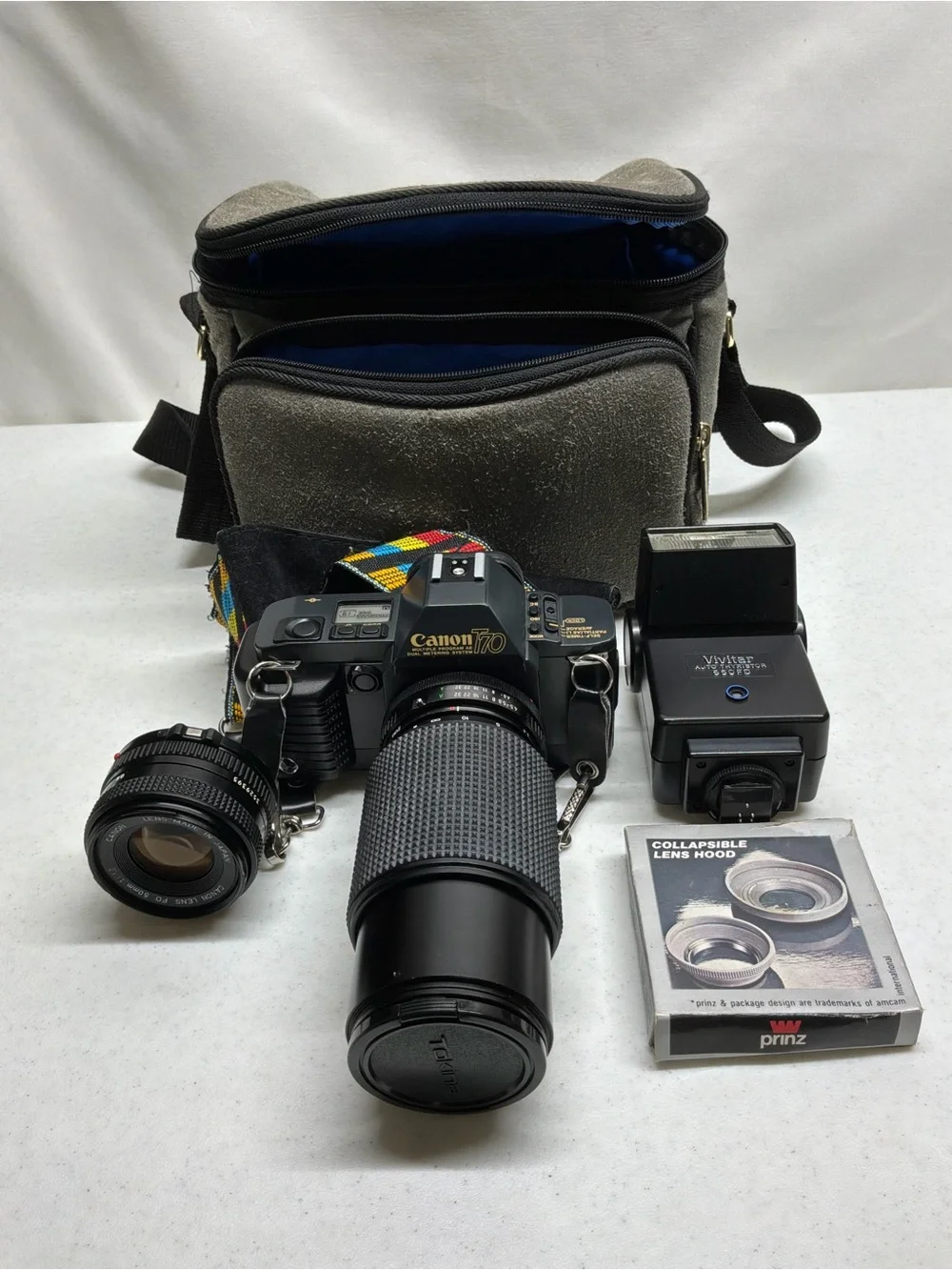 Canon T70 35mm SLR Camera with Black Telephoto Lens and Accessories